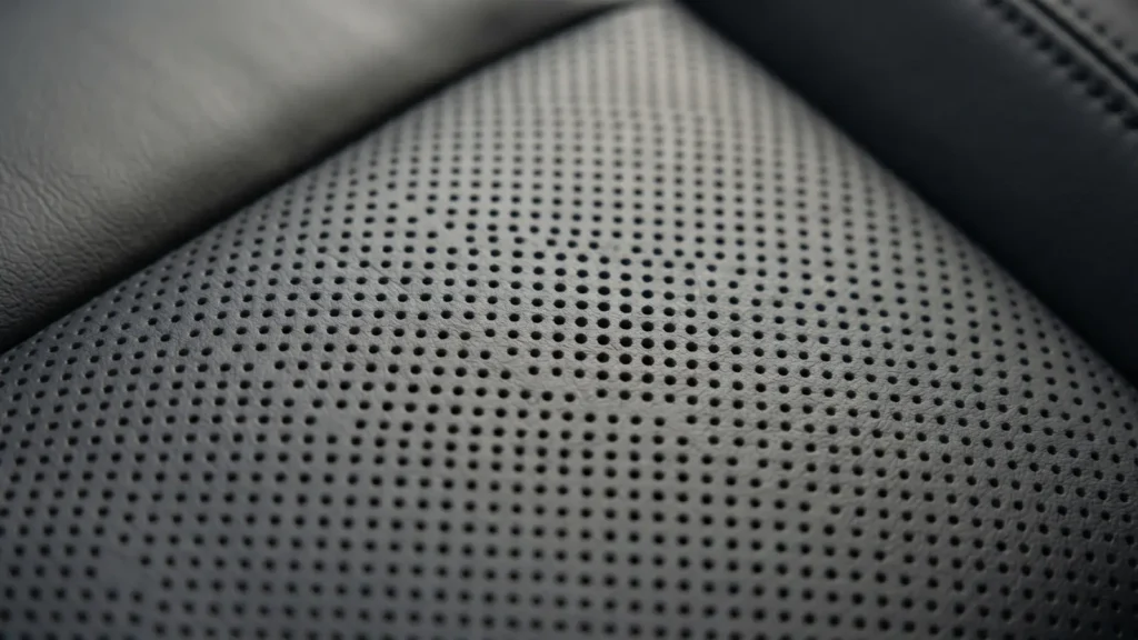 Close-up of ventilated seat perforations on Tesla Model Y Juniper requiring matching cover perforations
